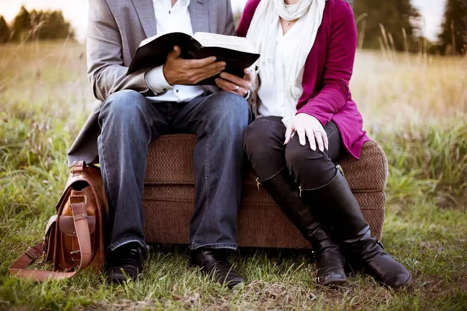 couple reading book outside